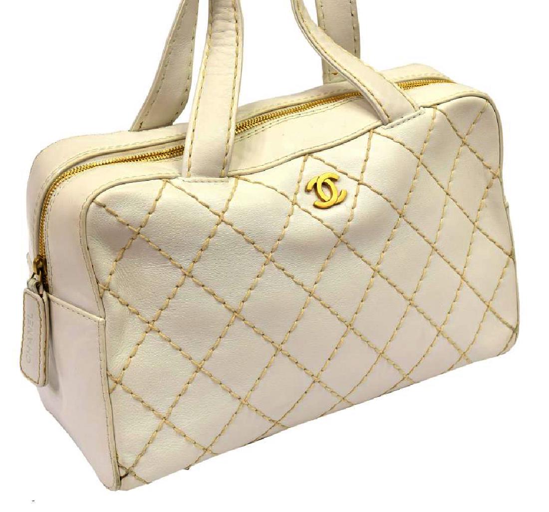 CHANEL WHITE DIAMOND STITCH LEATHER HANDBAG: Chanel handbag in white diamond stitch leather, gold tone hardware, open pocket on back exterior, double shoulder straps over zip close top, opening to zip and slot pockets, some surface dirt to top s