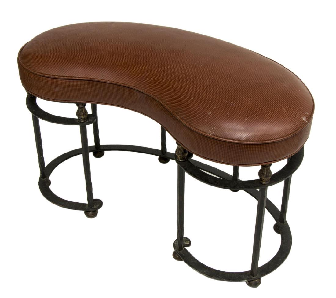 KIDNEY SHAPED LEATHER & IRON 'LYDIA BENCH': Contemporary kidney shaped "Lydia Bench," attributed to Murray's Iron Works, having embossed red leather upholstered seat, on wrought iron base, with parcel gilt acanthus topped supports, rising on bu