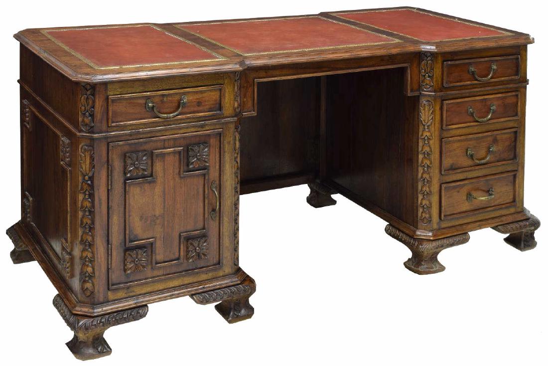 ANGLO-INDIAN DOUBLE PEDESTAL KNEEHOLE DESK: Anglo-Indian executive teakwood double pedestal kneehole desk, having rectangular top with canted corners and three inset leather writing surfaces, over five drawers and a single-door cabinet, all ris
