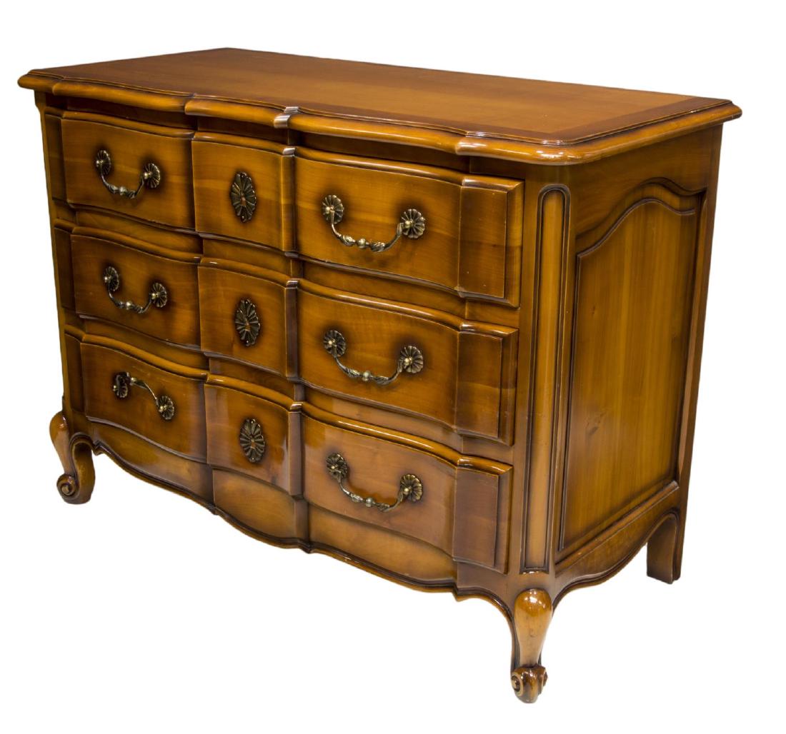 FRENCH LOUIS XV STYLE THREE DRAWER COMMODE: French Louis XV style cherrywood finish commode, late 20th c., the shaped top over three drawers, rising on scroll foot cabriole legs, retaing tag AFNOR "Trophee" tag of quality, 34.5"h, 47"w, 22"d St