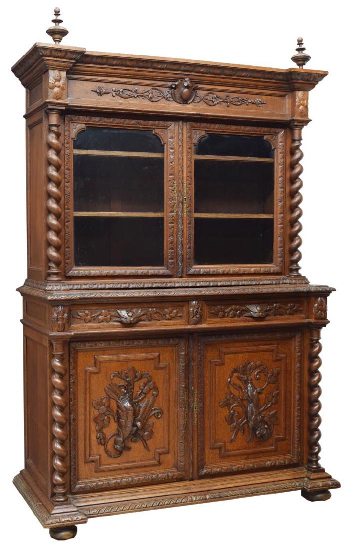 FRENCH HENRI II STYLE CARVED OAK GAME SIDEBOARD: French Henri II style oak sideboard with carved scens of the hunt, c. 1880, in the style popularized by Alexander Roux, having turned finials to top, acanthus molding accents throughout, cornice over