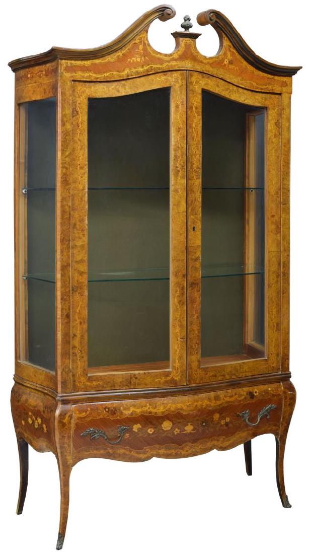 ITALIAN MARQUETRY & BURL VITRINE: Italian marquetry burl finish vitrine, early 20th c., a split pediment over two glazed doors opening to the shelved interior with glass sides, all rising on cabriole legs with brass faced feet, 73.25"