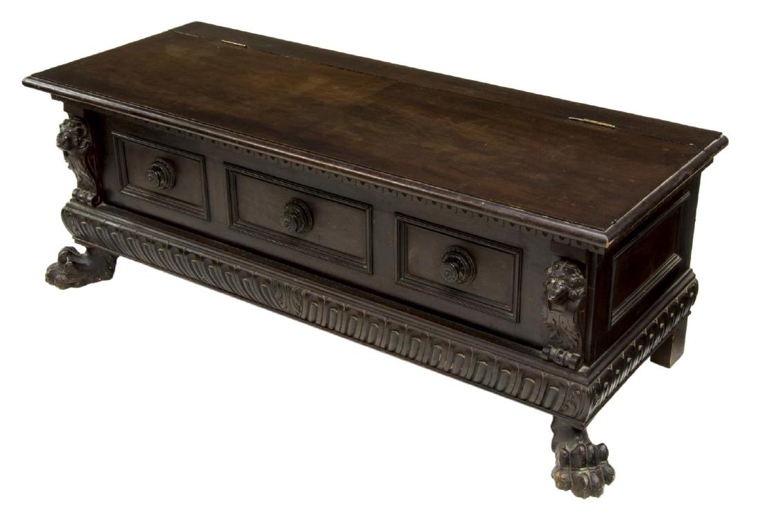 RENAISSANCE REVIVAL CARVED MAHOGANY HALL BENCH: Continental Renaissance Revival mahogany finish hall bench, c. 1900, rectangular top with hinged lid, storage to interior, above scoop molding, carved figural mask supports, floriform carved reserves 