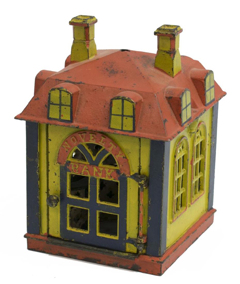 J. & E. STEVENS CO. NOVELTY BANK, PAT. 1872: Cast iron polychrome Novelty Bank, by J. & E. Stevens, Buffalo, New York, square building, door to front opens coin is placed on the teller's tray, door snaps closed as the teller throws coin into the