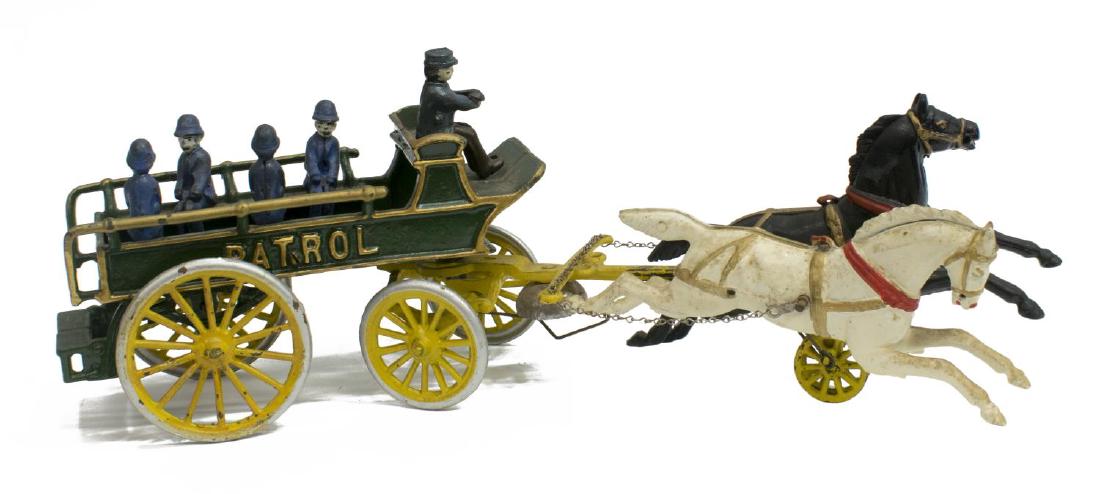DENT HARDWARE POLICE PATROL WAGON CAST IRON TOY: Cast iron police patrol wagon toy, c. 1910, by Dent Hardware Co., Pennsylvania, five figures, in green open bed wagon with bench seating and railed sides, rear platform, bright yellow spoke wheels, mo