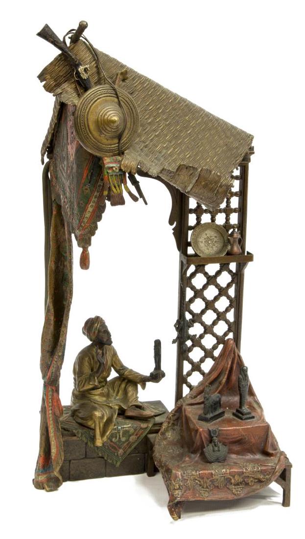 FRANZ BERGMAN BRONZE ANTIQUES SELLER LAMP, 15"H: Orientalist cold painted bronze lamp by Franz Xaver Bergman (Viennese, 1861-1936), formed as an open doorway with a man seated on a rug at the interior, the roof a bronze color with colorful hanging c