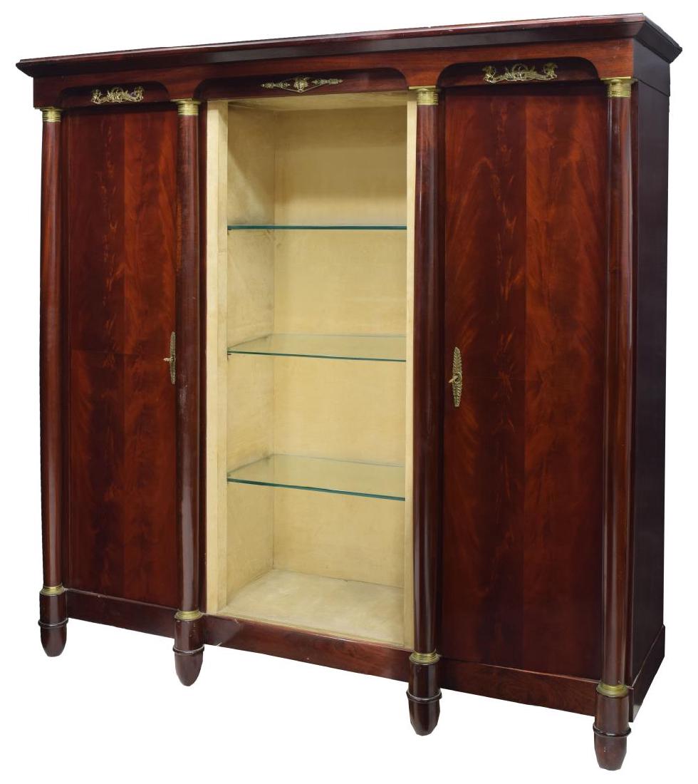 FRENCH EMPIRE STYLE ROSEWOOD BOOKCASE/WARDROBE: French Empire style rosewood finish bookcase/wardrobe, corniced top, above three recessed gilt metal ormolu reserves, featuring eagles, winged cupids, and masks, turned column supports, with gilt meta