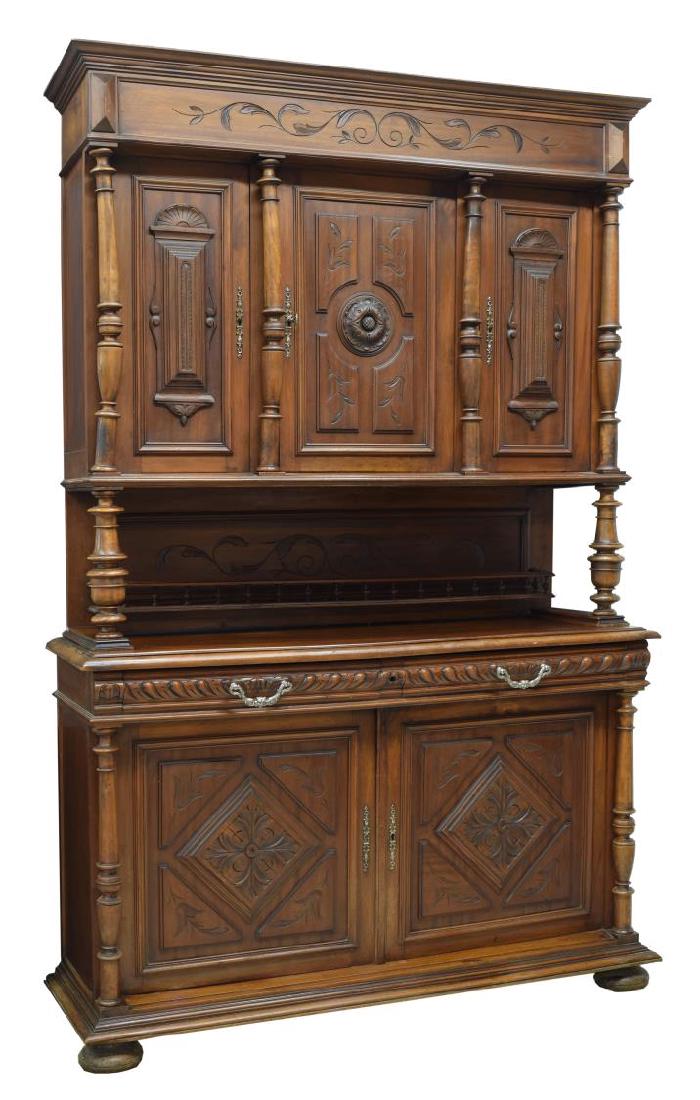 FRENCH RENAISSANCE REVIVAL DUX CORPS CABINET: Henri II style walnut double corps buffet, c. 1880, accented with incised foliate carving, the stepped cornice over three doors flanked by turned columns, the rectangular work surface above two frieze