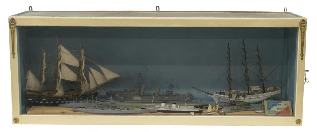 DIORAMA WITH TWELVE SHIPS: Ship diorama, 20th c., with twelve unique ships, presented in painted cabinet, accompanied by book of twelve postcards depicting French battleships, all postcards intact, some loss and wear to diorama