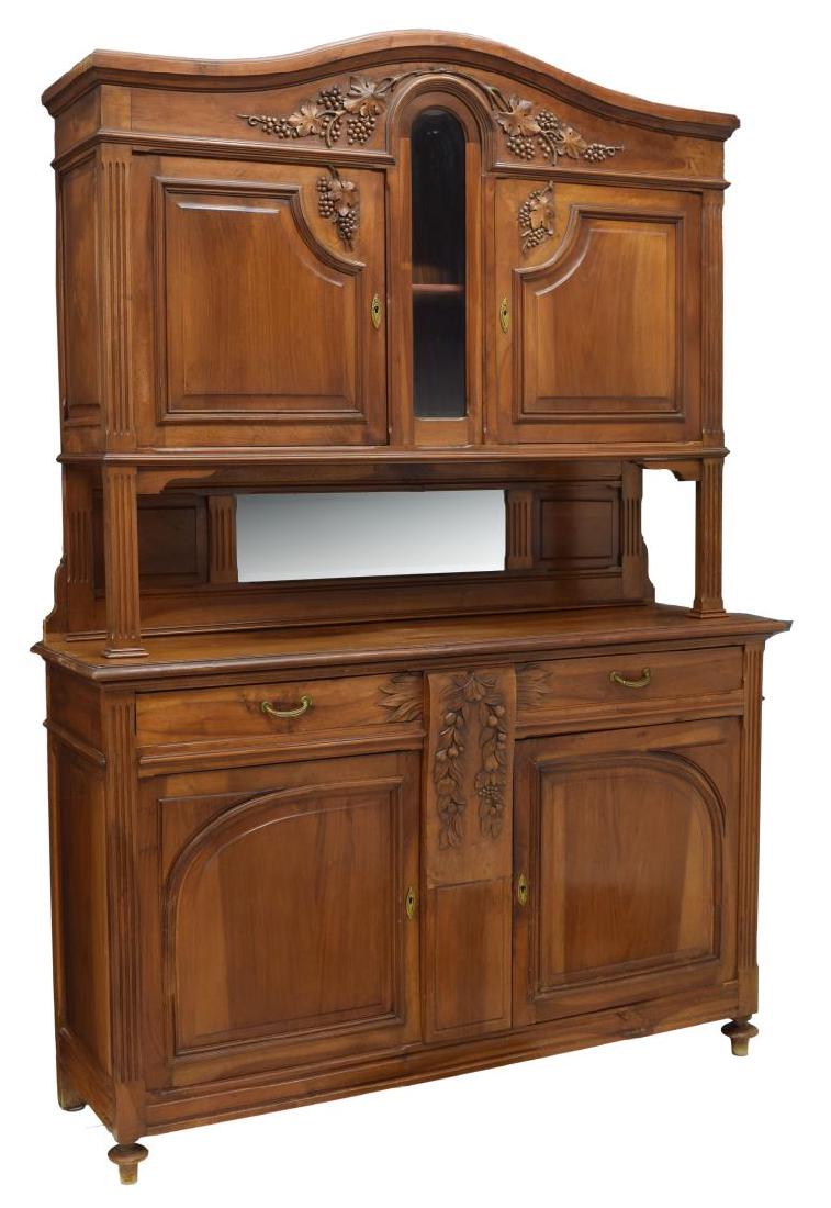 LOUIS XV STYLE BUFFET, C. 1900: Louis XVI style walnut buffet, c. 1900, accented with relief carved grapes and leaves, the arched cornice over two doors flanking a glazed center display area, the lower part with a rectangular work s