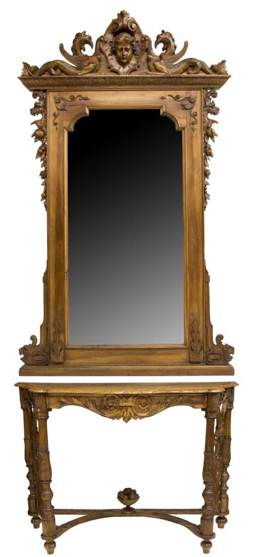 CARVED WALNUT CONSOLE TABLE AND FULL LENGTH MIRROR: Carved walnut console table with mirror, 19th c., figural mask and griffin carved pediment, over corniced top with acanthus molding, flanked by pierced and carved lion mask and foliate accents, shaped