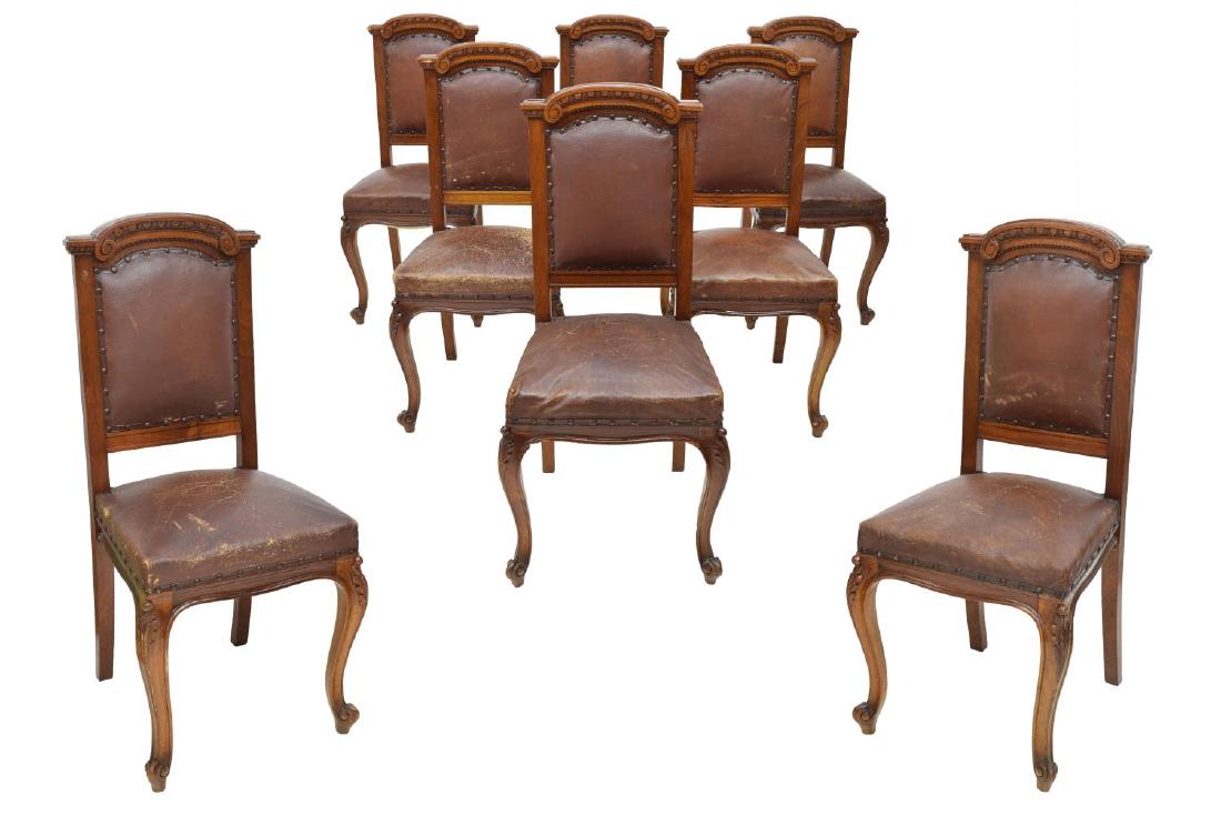 (8) ITALIAN ROCOCO STYLE CARVED WOOD DINING CHAIRS: (lot of 8) Italian Rococo style dining chairs, having scroll carved back, with brown imitation leather upholstery to back and seat, with nail head accents, rising on foliate carved cabriole legs, and