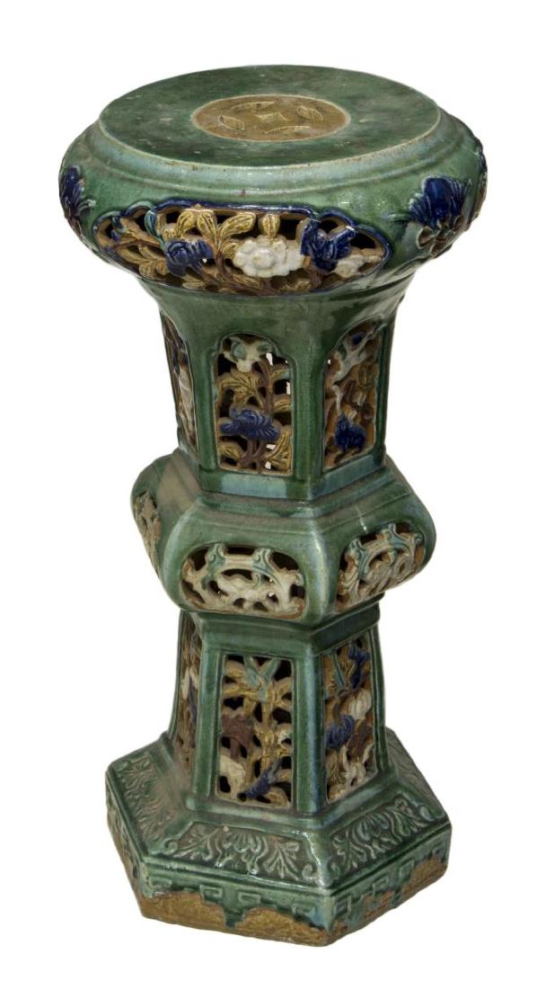AESTHETIC MAJOLICA GLAZED PIERCED JARDINIERE STAND: Majolica jardiniere stand, early 20th c., in the Chinese taste, with pierced panel sides, in blue, green, and brown tone glazes, approx 31"h, 14.75"diam Start Price: $100.00