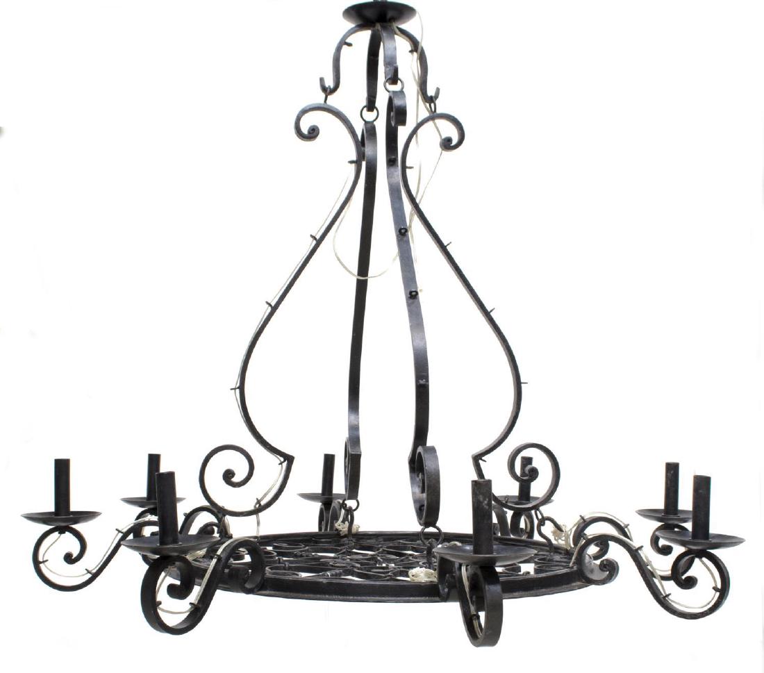 FRENCH COLONIAL WROUGHT IRON 8-LIGHT CHANDELIER: French Colonial wrought iron eight-light chandelier, having for scrolling arms above the pierced medallion plate, issuing eight scrolling arms terminating in bobeches and light sockets, from ceiling p