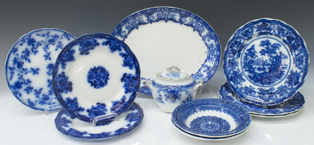 (9) STAFFORDSHIRE & OTHER FLOW BLUE TABLEWARE: (lot of 9) Collection of flow blue and blue and white table ware: (2) Staffordshire Waldorf flow blue plates, (1) Hanley "Colonial" pattern plate with gilt accents, (2) W. Adams, "Fairy Villas" patter