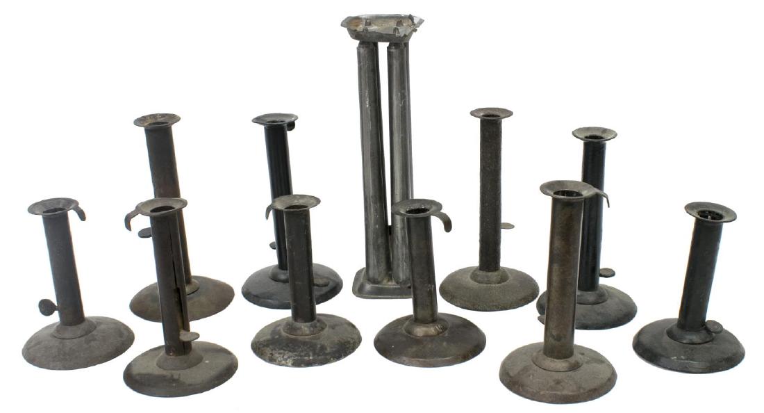 (11) ANTIQUE HOG SCRAPER CANDLESTICKS & TIN MOLD: (lot of 11) American metalware, including: (10) hog scraper candlesticks, 19thc., several with remnants of paint, (1) tin four-tube candle mold, largest: 10.5"h, 4.75lbs total ** Provenance: Estate of