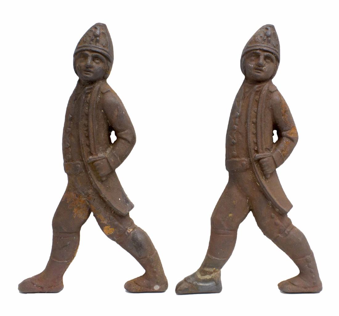(2) AMERICAN CAST IRON HESSIAN SOLDIER ANDIRONS: (pair) American cast iron figural andiron fragments, 19th c., modeled as Hessian soldiers, approx 19.25"h, 10.5"w, 12lbs ** Provenance: Estate of Mrs. E.M. (Mary) Drew (1923-2015), Drew's Antiques & P
