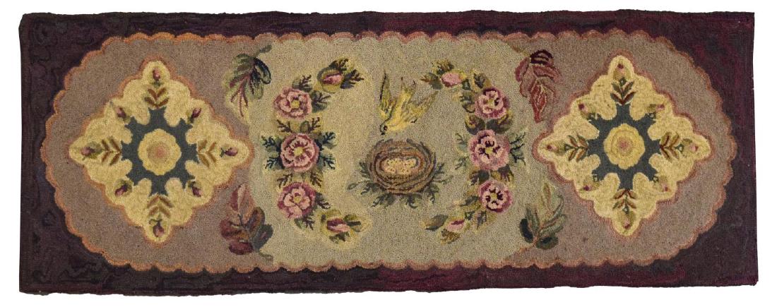AMERICAN HAND-HOOKED WALL HANGING, C. 1900: Hand-hooked wall hanging, America, c. 1900, having purple border, around polychrome floral design, with bird and nest to center, having wooden rail to back, approx 56.25"l, 21.5"w ** Provenance: Estat