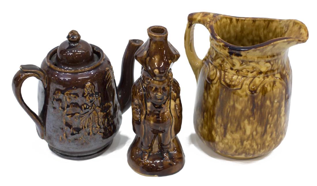 (3) AMERICAN ROCKINGHAM POTTERY, TOBY BOTTLE FLASK: (lot of 3) American Rockingham pottery, 19th c., with mottled brown glaze, including: (1) Toby bottle flask, approx 7.75"h, 3"diam, (1) teapot, depicting Rebecca at the well, chip to lid, approx 7.25"