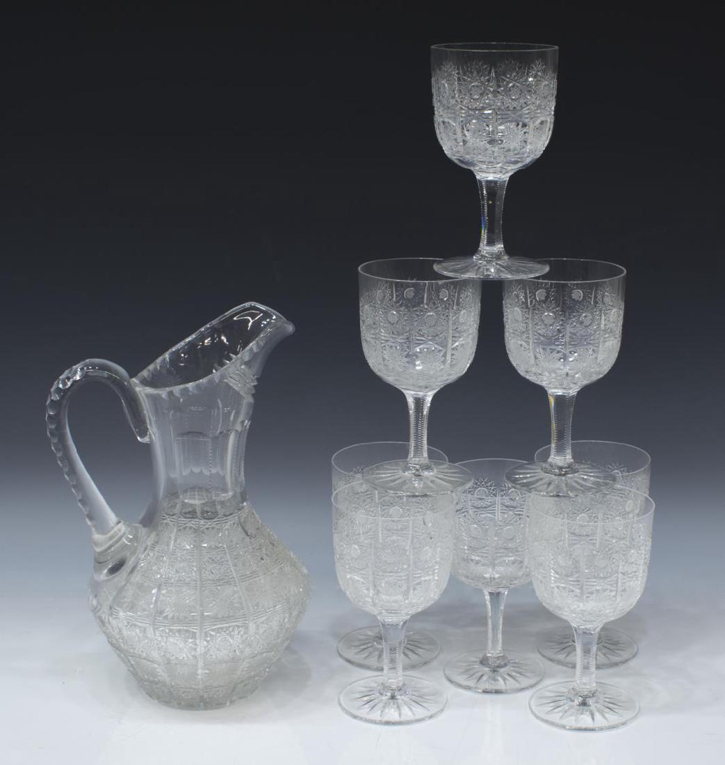 (9) NOTCHED & STAR CUT CRYSTAL DRINKS SERVICE: (set of 9) Colorless cut crystal/ glass drinks service, all cut in star pattern, comprising: (1) pitcher, having notched handle, 11"h; (8) goblets, notched stems, 8"h; 8lbs total **Provenance: Estate 