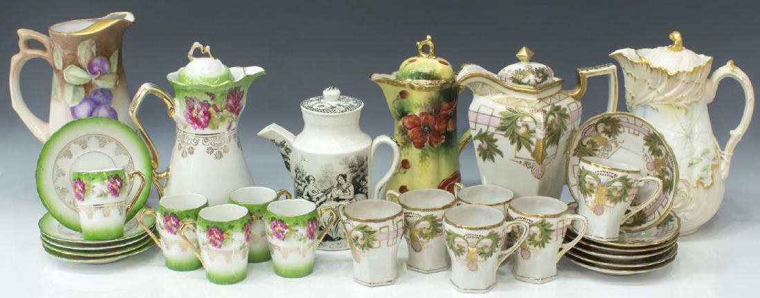 HUGE GROUP PORCELAIN CHOCOLATE SETS & TEAPOTS: (lot) Collection of porcelain chocolate and teapots, highlights include: (1) hand painted MR France lidded pot, raised parcel gilt shell motif, painted with flowering vines; (13pc) TT Nippon parcel gi