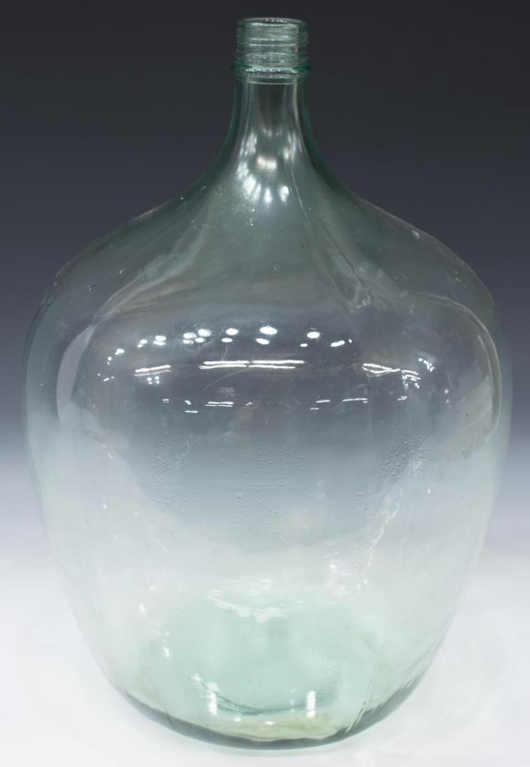 LARGE CONTINENTAL GREEN GLASS WINE BOTTLE: Large Continental wine bottle, in green glass, molded form, with thin threaded neck, over bulbous balloon form body, marked 20 G 25 around rim, approx 20"h, 13"diam, 10.5lbs Start Price: $60.00