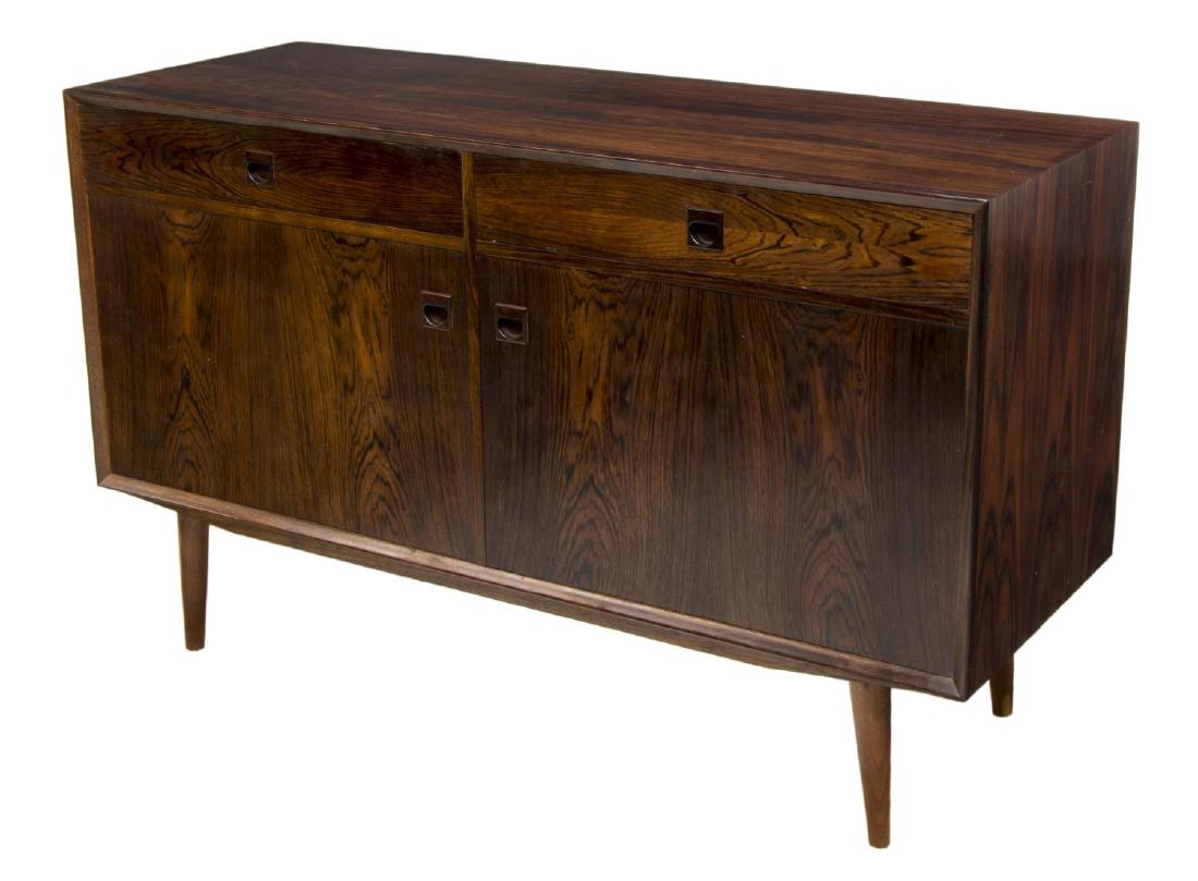 DANISH MID-CENTURY MODERN ROSEWOOD SIDEBOARD: Danish mid-century modern rosewood sideboard, c. 1960's, rectangular body, fitted with two drawers and two cabinets, with recessed pulls, shelves to interior of cabinets, rising on turned tapered legs