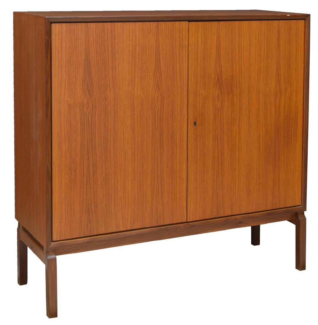 DANISH MID-CENTURY MODERN TEAKWOOD CUPBOARD: Danish mid-century modern teak cupboard, c. 1950's, with two cabinet doors, drawers and shelves to interior, rising on square legs, approx 43"h, 43.5"w, 15.75"d Start Price: $150.00