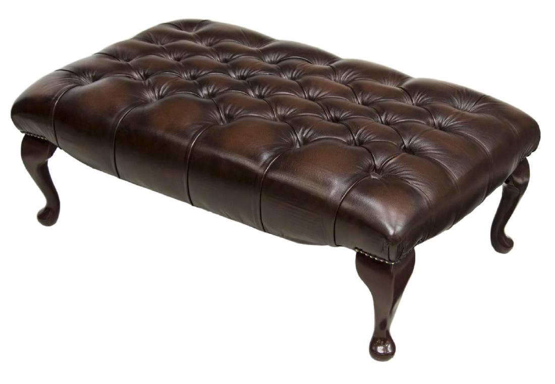 LARGE BROWN LEATHER CHESTERFIELD FOOT STOOL: Large Chesterfield foot stool, c. 1980's, with brown leather tufted top, rising on cabriole legs, with pad feet, approx 13.5"h, 37"w, 22.25"d Start Price: 150.00