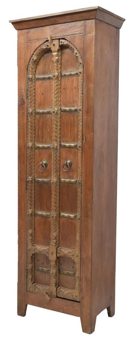 TALL TEAKWOOD TWO DOOR STORAGE CABINET: Tall teakwood cabinet, a protruding cornice over the two paneled doors with carving and iron hardware, rising on bracket feet, shelves to the interior, 85.5"h, 27"w, 15"d Start Price: $150.00