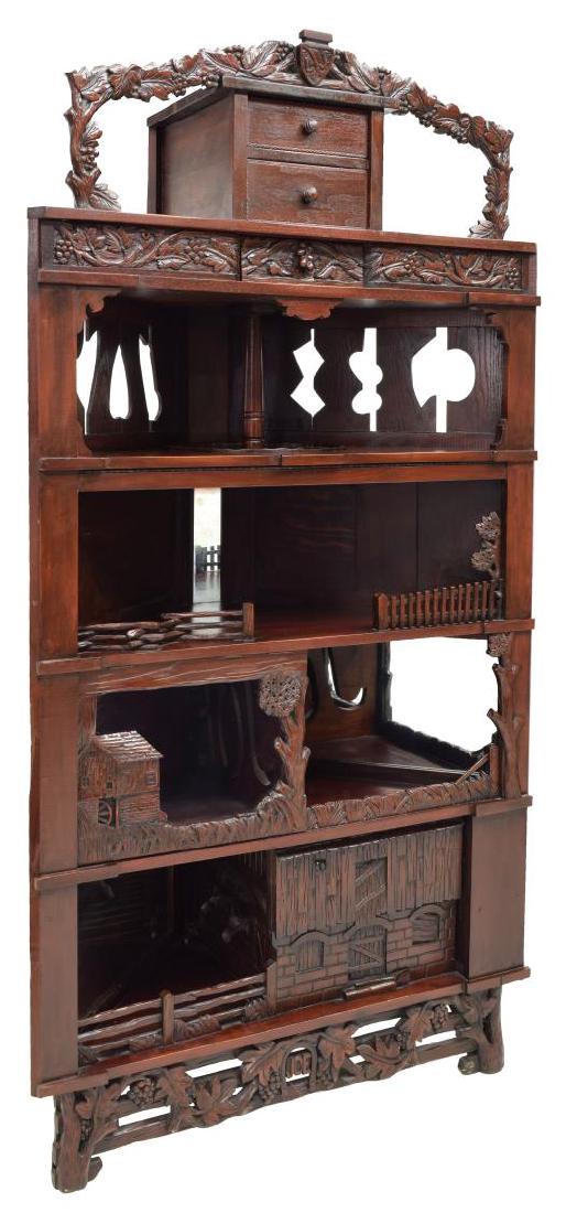 BLACK FOREST HEAVILY CARVED CORNER CABINET: Heavily carved Black Forest corner cabinet, a shield crest flanked by leaf and berry carved arch over two drawers, foliate carved frieze with hidden drawer to center, top shelf with lazy Susan, bottom