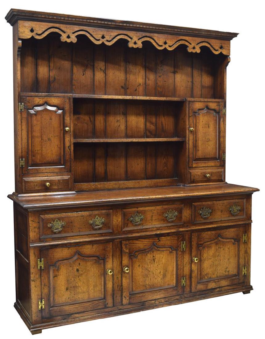 TITCHMARSH & GOODWIN OAK KITCHEN DRESSER/SIDEBOARD: Oak kitchen dresser/sideboard, by Titchmarsh & Goodwin, Suffolk, England, having corniced and dentil molded top, with pierced and carved frieze, over open shelves, flanked by cabinets, with shelves to