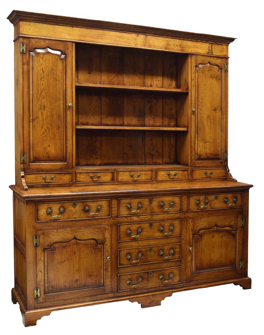 OAK WELSH STYLE CUPBOARD/KITCHEN DRESSER: Oak Welsh style cupboard/kitchen dresser, a corniced top over open shelves, flanked by cabinets with brass knobs, shelves to interior, the base fitted with six drawers and two cabinets, on bracket fee