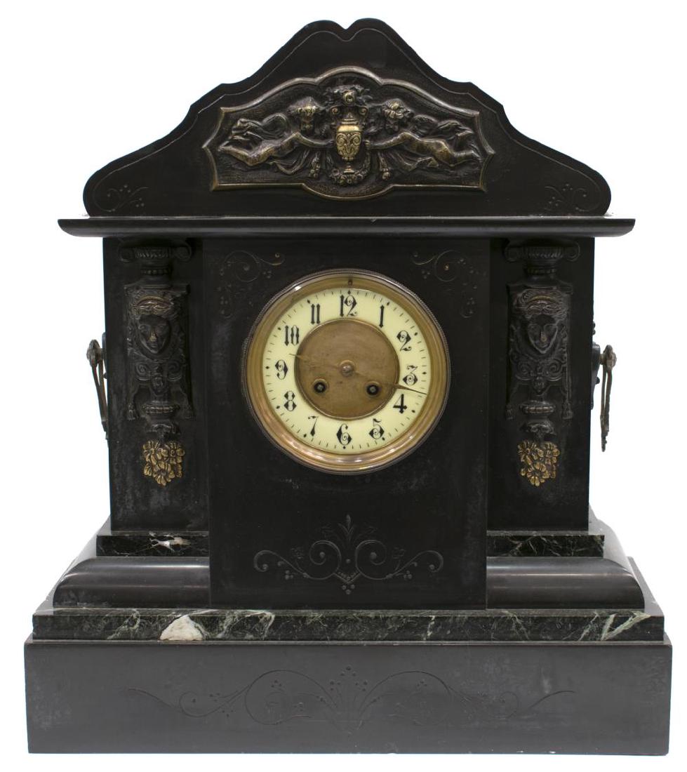 LATE VICTORIAN SLATE & MARBLE CASED MANTLE CLOCK: Late Victorian slate and marble mantle clock, c. 1890, pediment top with frieze of winged putti holding an urn, over circular white enamel face with black Arabic numerals, flaked by female masks, cast