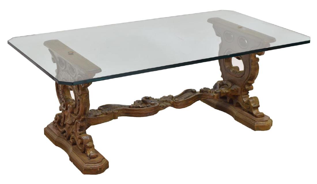 ROCOCO-STYLE CARVED WOOD GLASS TOP SOFA TABLE: Rococo-style sofa table, c. 1980's, having clear glass top, over pierced and carved trestle base, with scroll and foliate design to legs and stretcher, rising on stepped plinth feet, approx 17.5"h, 47