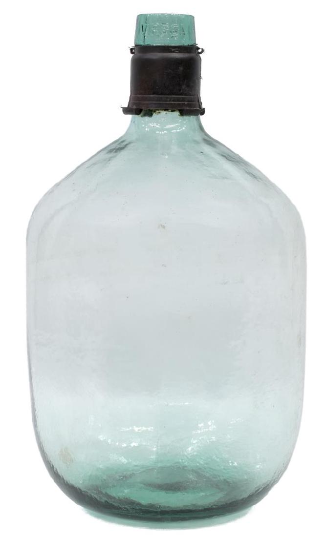 LARGE CONTINENTAL GREEN GLASS WINE BOTTLE: Large Continental wine bottle, in green glass, molded form, with thin neck, over bulbous body, marked 10 L VIRESA around rim, retaining black plastic cap remnant, approx 16"h, 9"diam, 4.2lbs Start Pri