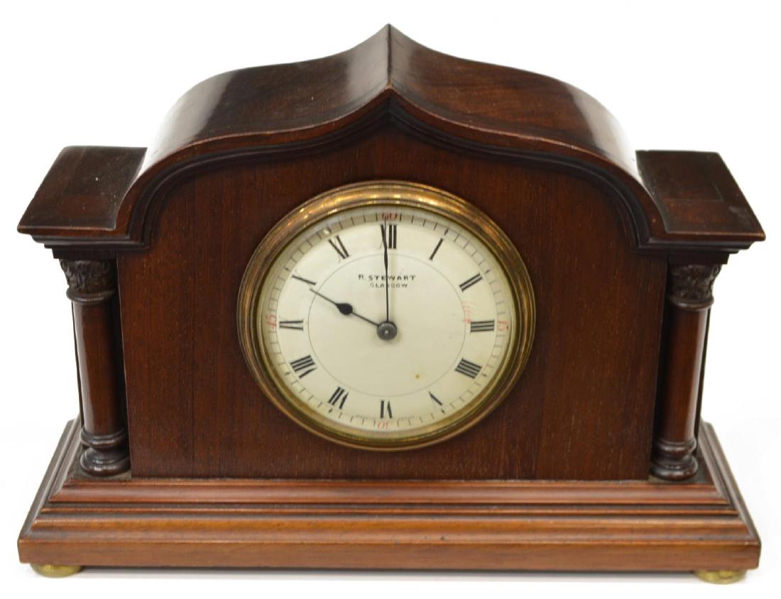 EDWARDIAN MAHOGANY R. STEWART MANTLE CLOCK: Edwardian mahogany mantle clock, R. Stewart, Glasgow, c. 1900, diminutive shaped case on round gilt metal feet, retaining key, not operating at this time, 7"h, 10"l, 3.5"w, 4lbs Start Price: $40.00