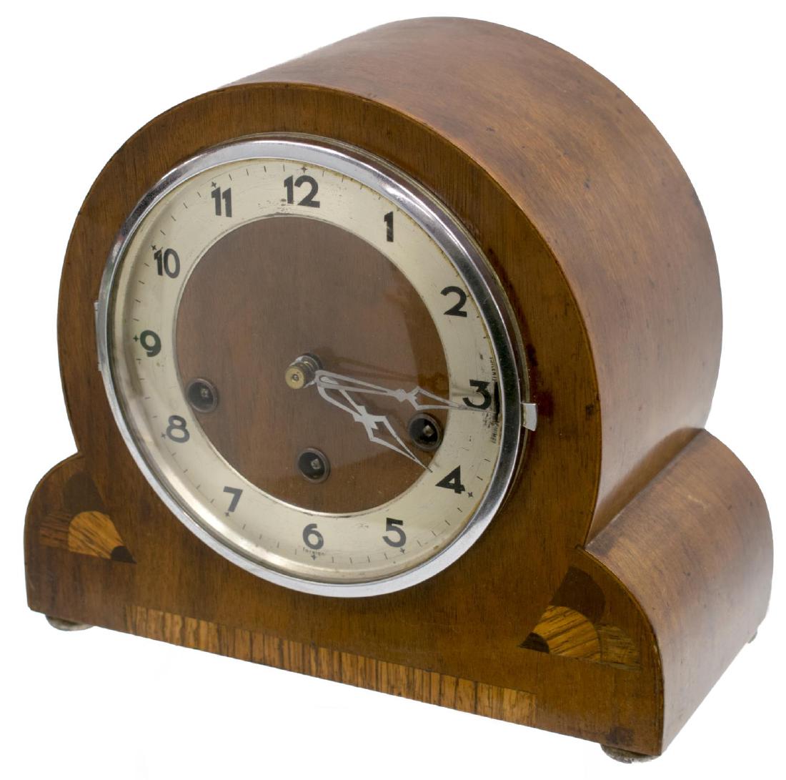 GERMAN GUFA ART DECO WALNUT INLAID MANTLE CLOCK: Art Deco Westminster chiming mantle clock, Gufa, Germany, the walnut case with inlaid accents raised on short bun feet, circular metal dial with Arabic numerals, enclosing three key holes, interior wo