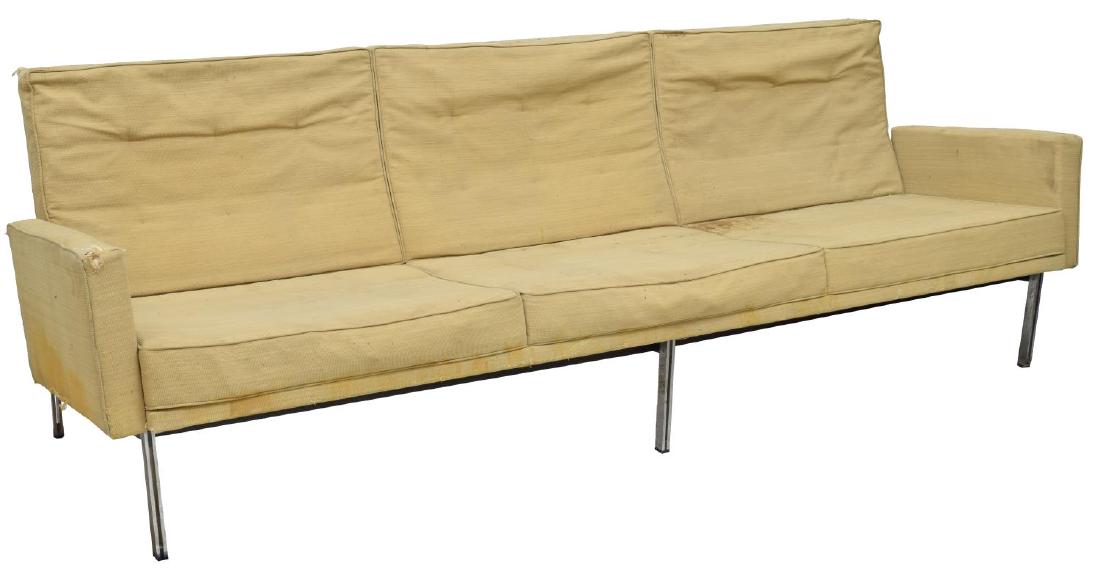 FLORENCE KNOLL PARALLEL BAR SOFA, MODEL 57: Early "Parallel Bar" sofa, Model 57, designed by Florence Knoll (United States, b.1917), three cushions framed by squared arms, all rising on steel base, original upholstery with stains, tears, foam h