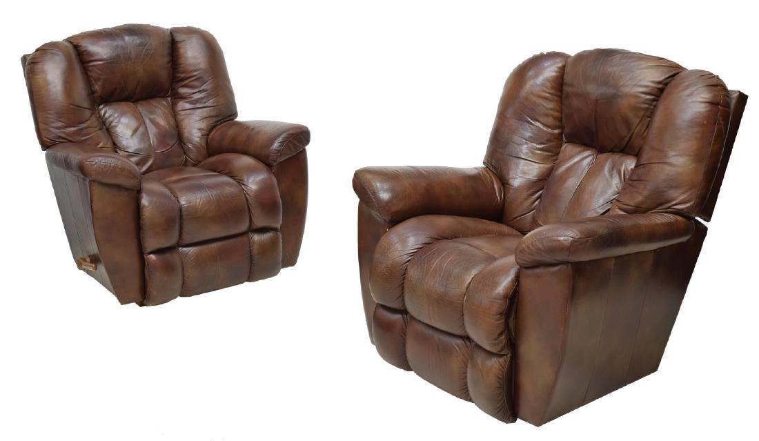 (2) BROWN LEATHER LA-Z-BOY RECLINERS: (pair) Brown leather upholstered recliners by La-Z-Boy, having straight padded back over arms and extending foot rest, plastic handle to side, some discoloration, approx 41"h, 39.5"w, 42"d Start Price