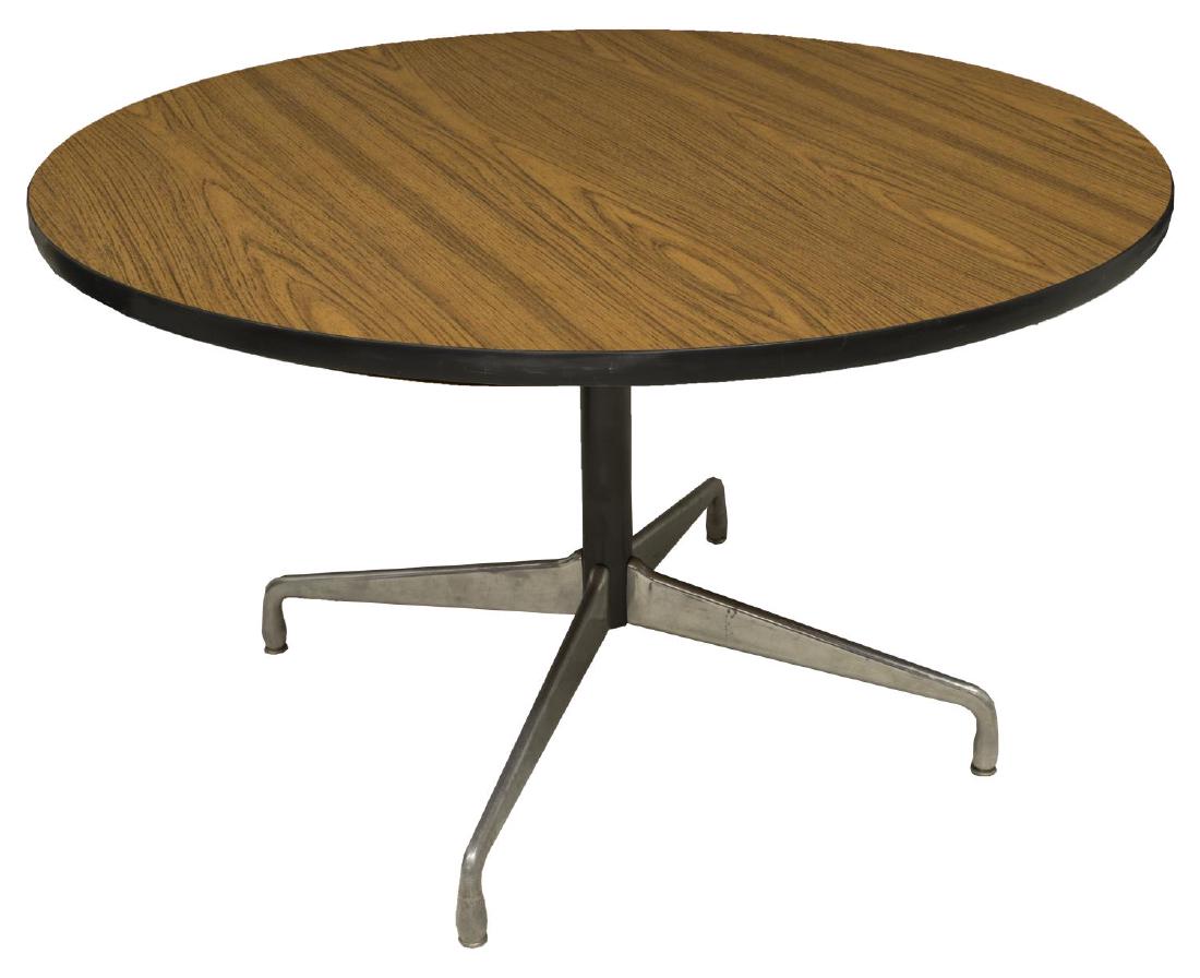 MID-CENTURY MODERN ROUND TABLE, HERMAN MILLER: Mid-century modern round table, design by Charles Eames (United States, 1907-1978) for Herman Miller, oak veneer top, rising on steel pedestal, with quadripartite base, approx 29"h, 48"diam Start Pric