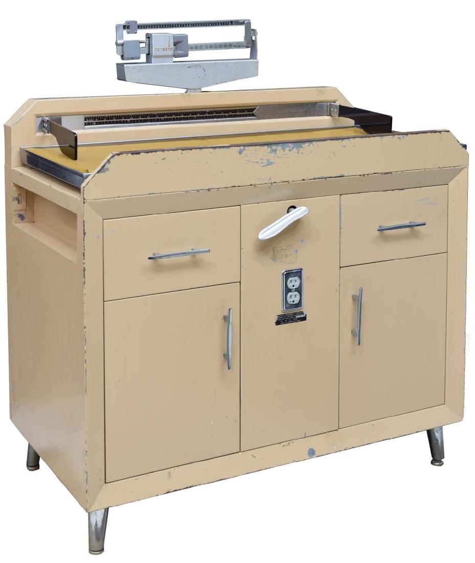 DETECTO HOSPITAL DOCTOR'S BABY TABLE/SCALE: Hospital doctor's baby table by Detecto, scale top with padded surface, scale has 130lbs weight capacity, length measuring device also to top, metal body fitted with two drawers and two cabinets with 