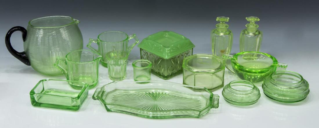 (14) COLLECTION OF VASELINE GREEN GLASS: (lot of 14) Vaseline glass, highlights include: (1) pitcher, with black handle, approx 5"h, (4 piece) vanity set, comprising (one) tray, approx 10.25"l (one) covered box, approx 2"h, 3.75"w, (two) per