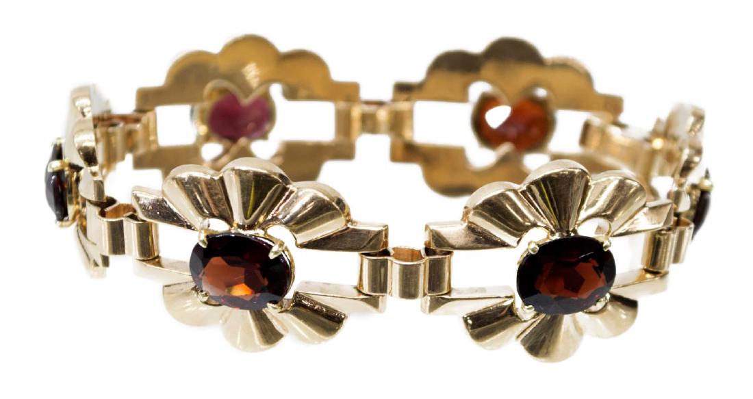 ESTATE RETRO MODERN 14KT & GARNET LINK BRACELET: Ladies estate Retro Modern 14kt yellow gold link bracelet, each in an abstract floral form and centered with (6) oval cut garnet stones, approx. 10mm x 7.5mm, marked on clasp, 7"l, 24.8 grams (inclusi