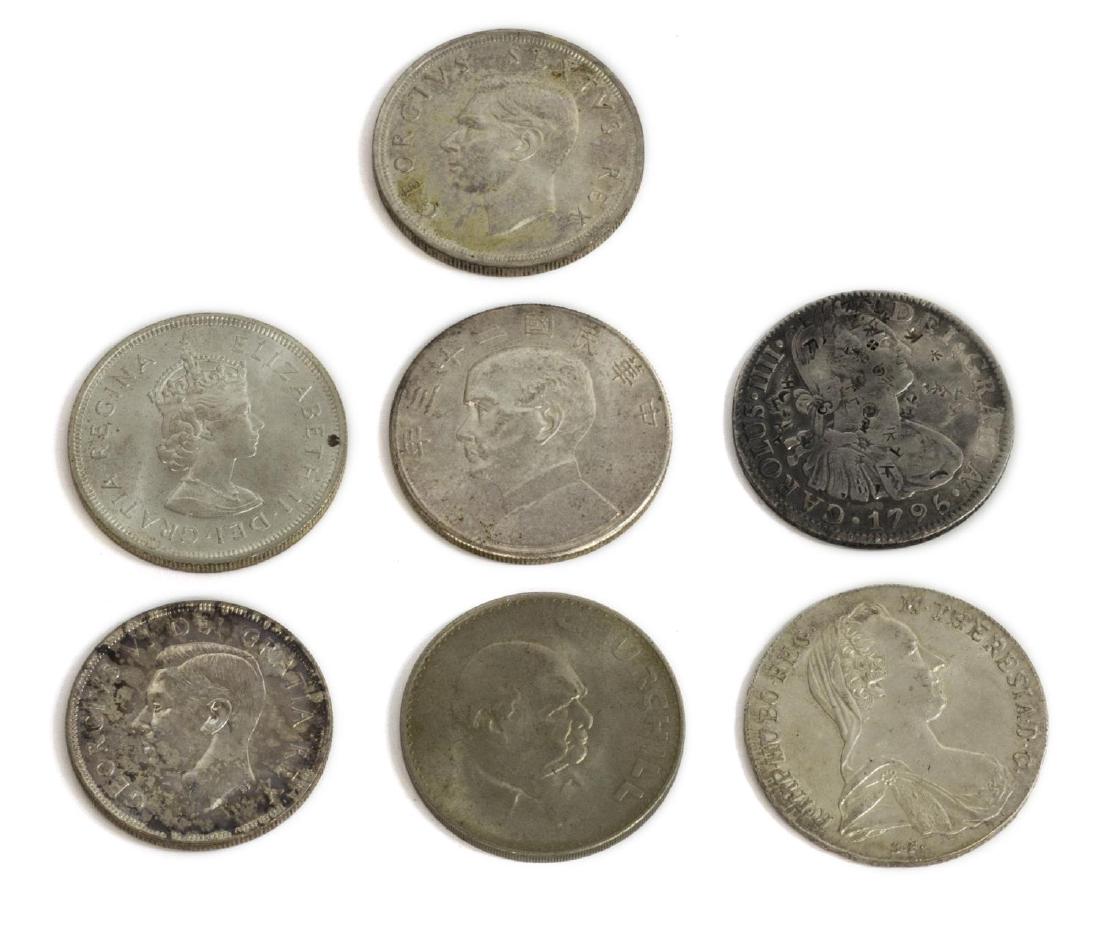 (7) GROUP OF WORLD DOLLAR SIZE COINS: (lot of 7) World coins: (1) 1795 Spanish colonial Carolus IIII Dei Gratia 8 reales silver coin; (1) 1780 Maria Theresa Thaler silver trade coin; (1) 1965 British Crown Winston Churchill 1965; (1) 1952