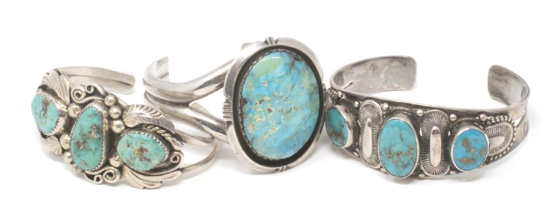 (3) SOUTHWEST STERLING & SILVER TURQUOISE CUFFS: (lot of 3) Southwest Native American silver and turquoise cuff bracelets: (1) marked sterling and signed S.E. Lee?, having three stones in a surround of bead and feather; (1) with large central stone,