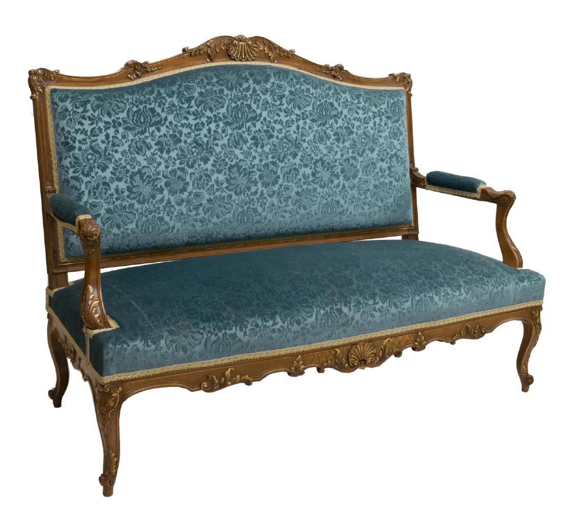 LOUIS XV STYLE PARCEL GILT CARVED WALNUT SOFA: Louis XV style parcel gilt carved walnut sofa, 19th c., with blue fabric upholstery, the scroll and shell form crest over scrolled arms, rising on cabriole legs with scroll feet, approx 42.75"h, 58"w,