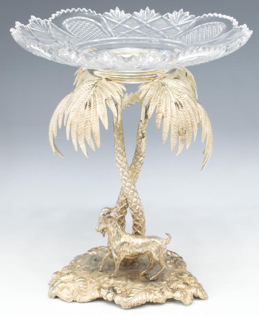 ORIENTALIST SILVER PLATE EPERGNE: Orientalist silver plate epergne, a cut glass bowl on a sculpture depicting a goat beneath a palm tree, bowl: 9" diameter, sculpture: 9.5"h, 6.5"w, 6"d, total: 4.75lbs Start Price: $80.00