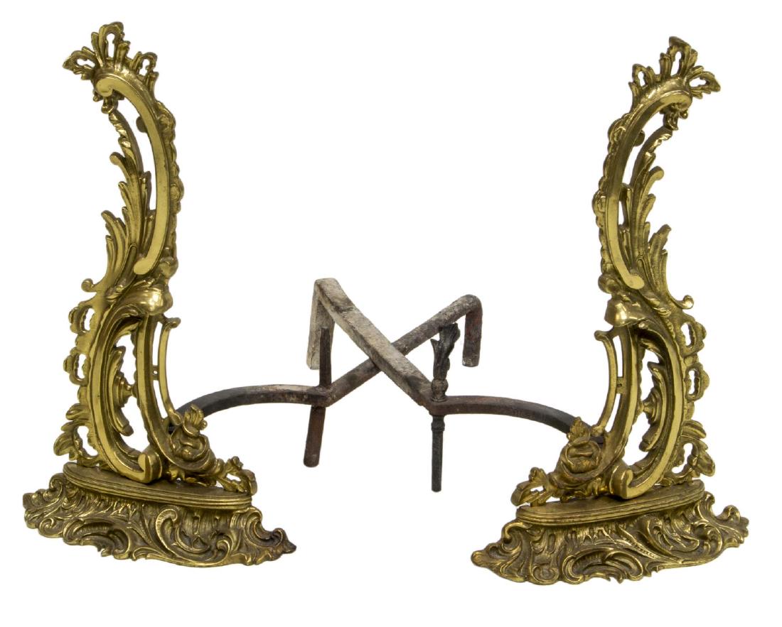 (2) LOUIS XV GILT METAL SHELLFORM ANDIRONS: (pair) Louis XV style gilt metal andirons, having pierced and scrolled shell form fronts, over flared scroll accented base, cast iron leg to back, approx 20.5"h, 12"w, 23.25"d, 18lbs total Start Price