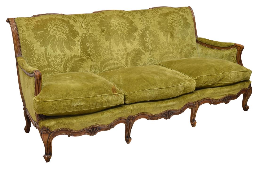 ITALIAN ROCOCO STYLE WALNUT THREE-SEAT SOFA: Italian Rococo style walnut three-seat sofa, 19th c., in green floral upholstery with nail head accents, the scroll shaped back over three removable cushions, rising on trifid foot cabriole legs, appr